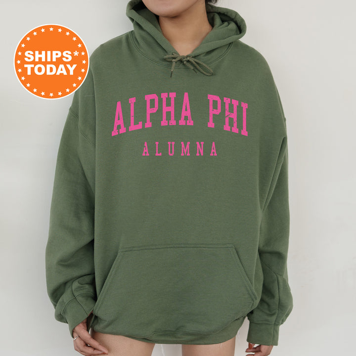 a woman wearing a green hoodie with pink letters on it