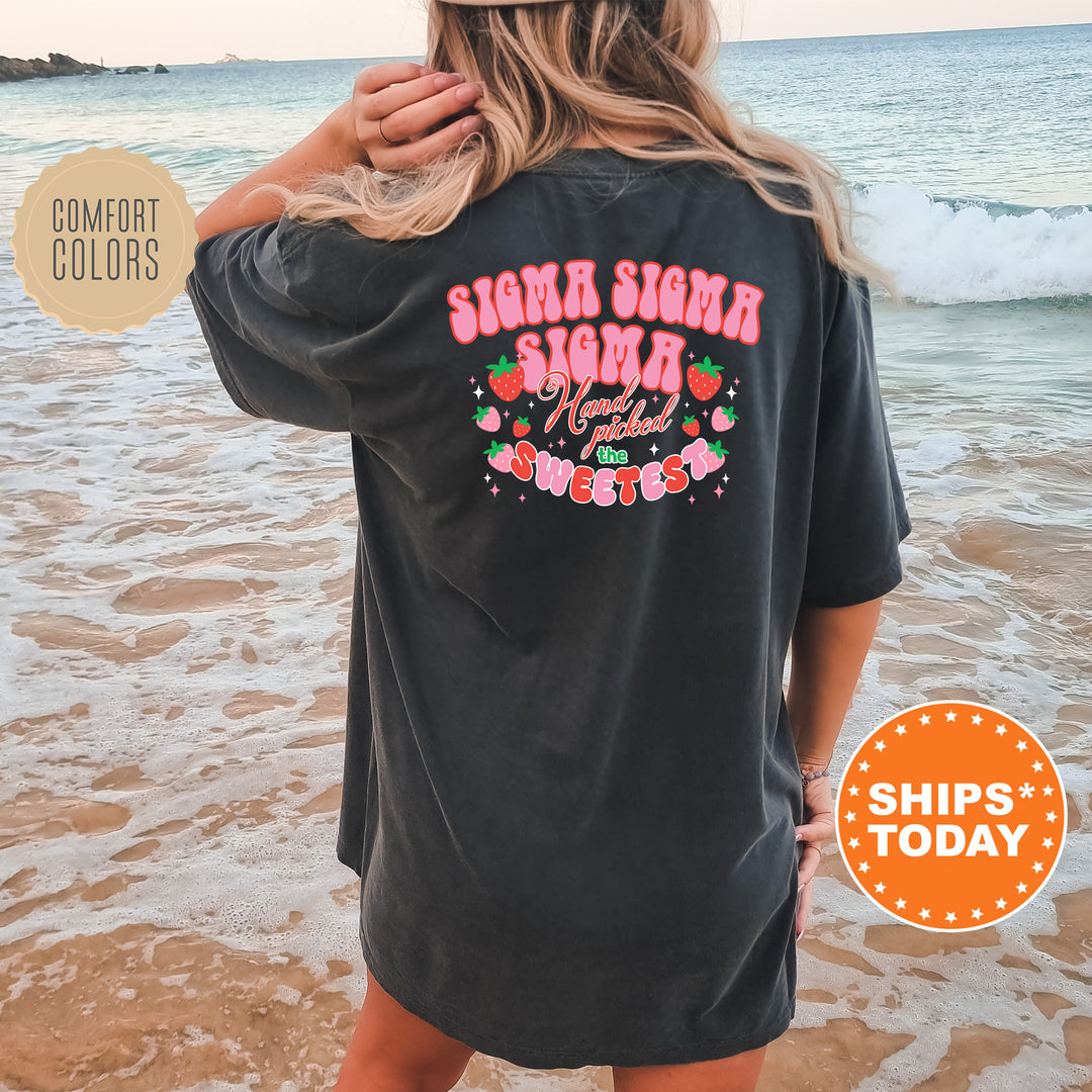 a woman standing on a beach wearing a black shirt
