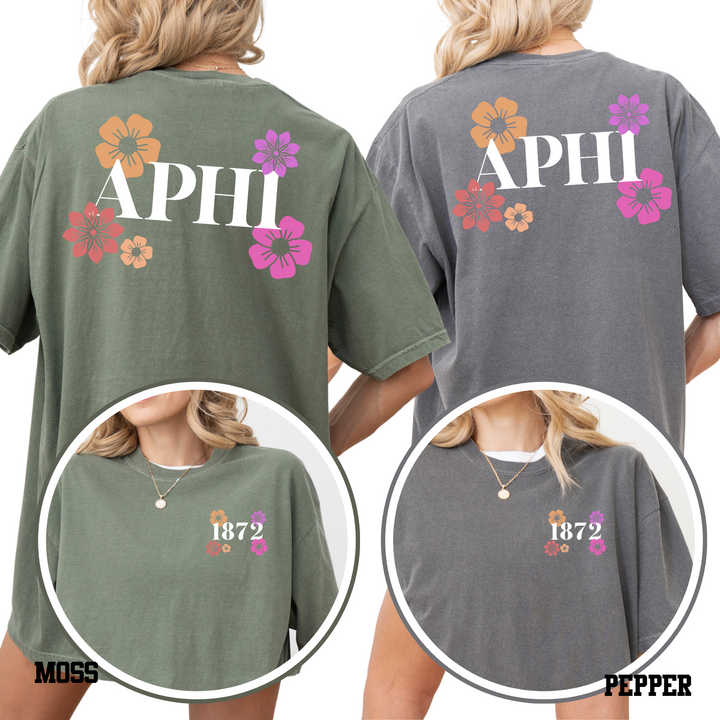 two women wearing t-shirts with floral designs and the text "APHI" printed on them.