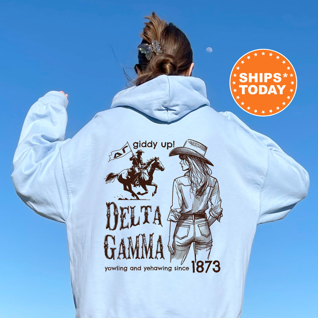 a woman wearing a white hoodie with a picture of a woman riding a horse