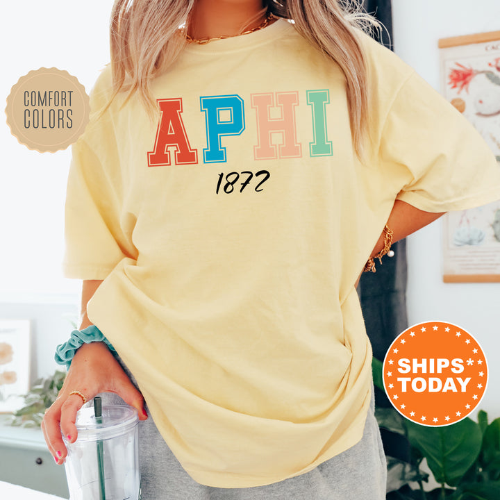 a woman wearing a yellow shirt with the word aphi on it