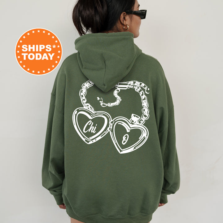 A person wearing a green hoodie with a graphic design on the back.