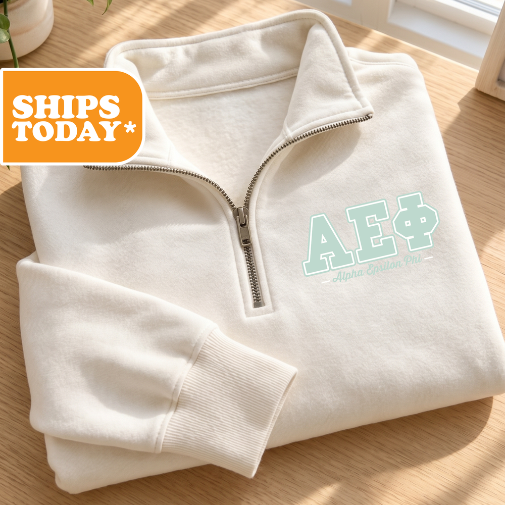 A white zip-up jacket with the Greek letters "ΑΕΙΚΑΙ" (Alpha Delta Phi) printed on it, along with a shipping label and a "SHIPS TODAY" sign.