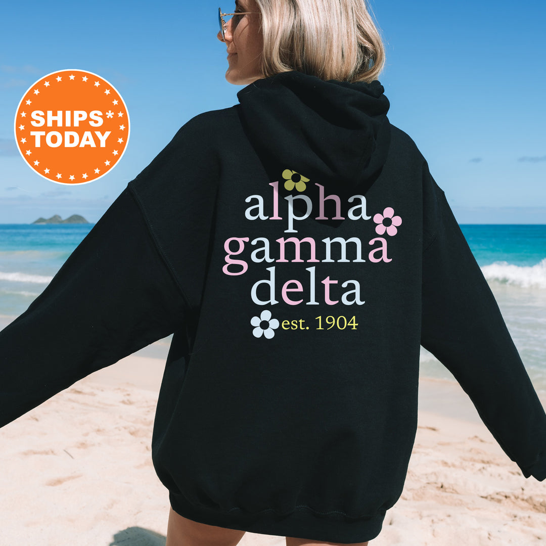 a woman in a black hoodie on the beach