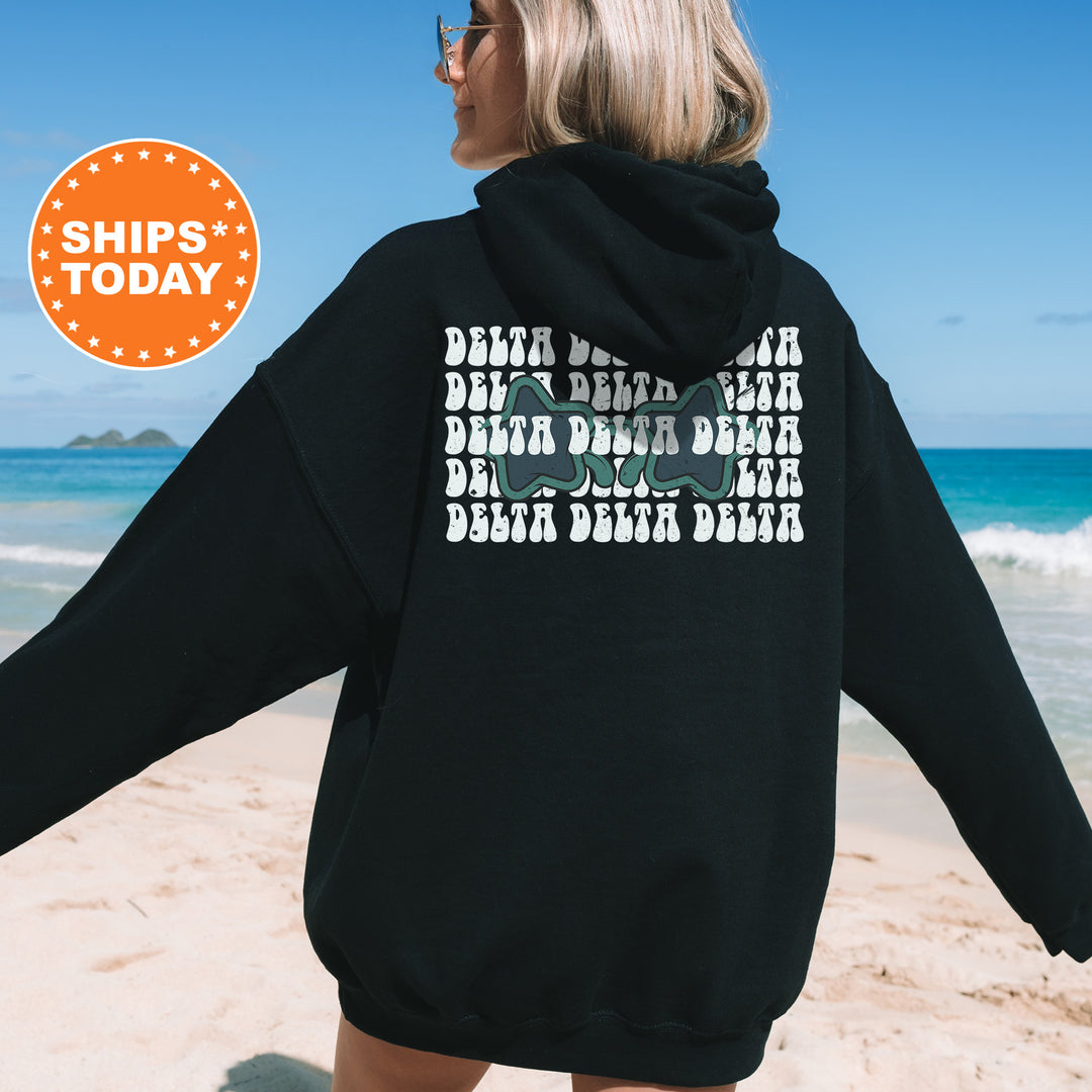 a woman wearing a black hoodie on the beach