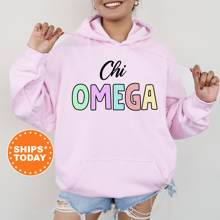 a woman wearing a pink hoodie with the word omega printed on it