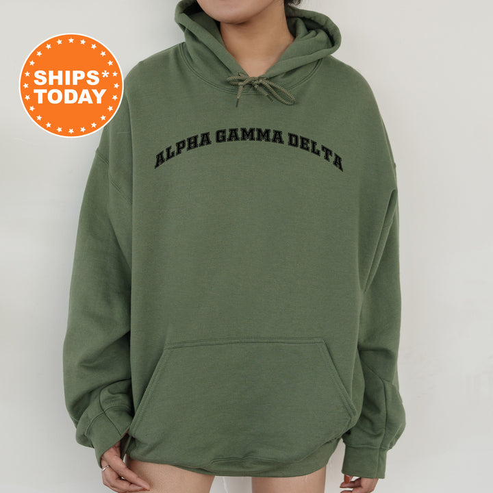 a woman wearing a green hoodie with the words alpa gama delta on