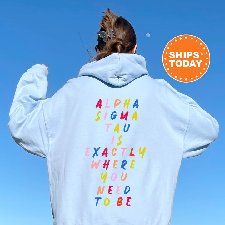a woman wearing a white hoodie with letters on it