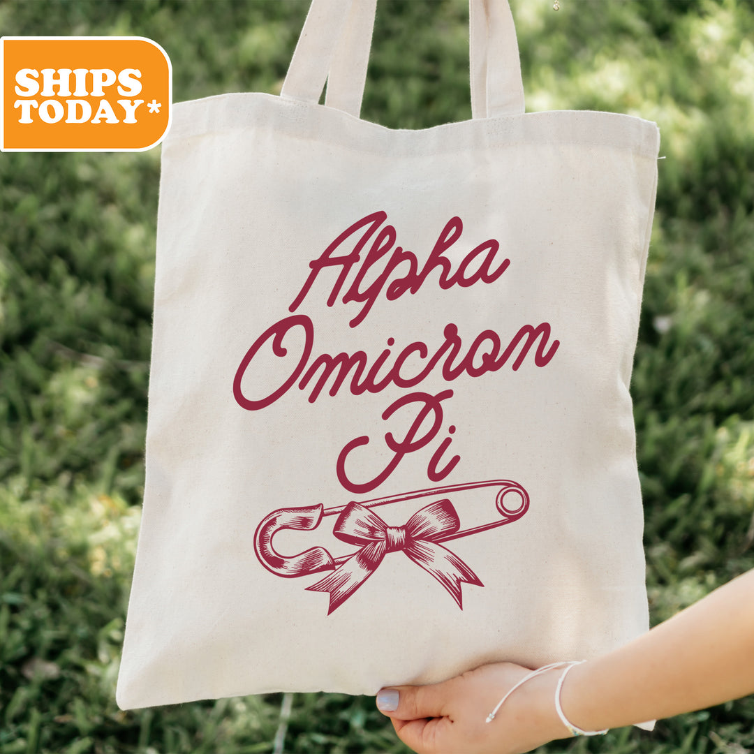 a person holding a tote bag with a ribbon on it