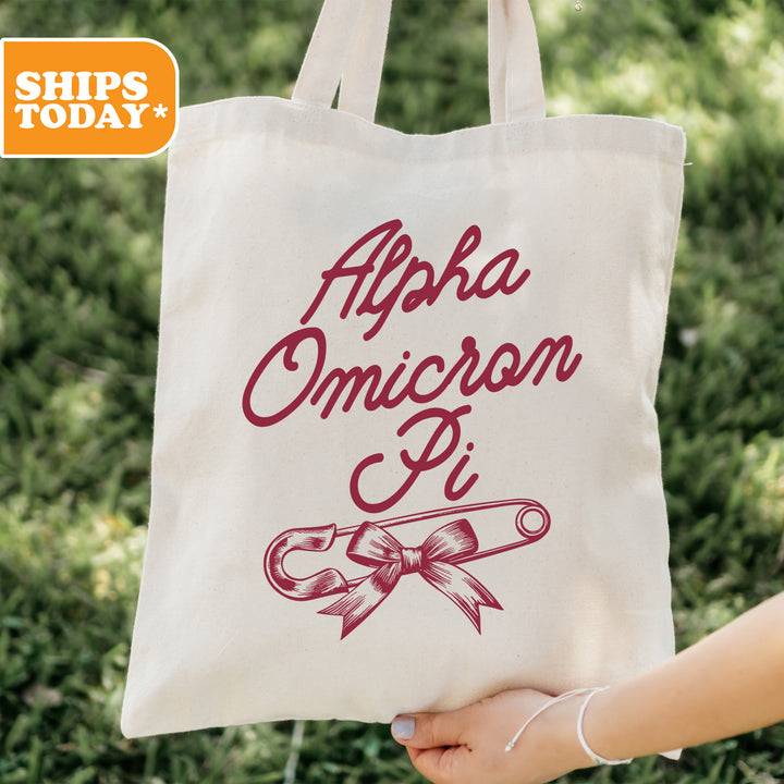 a person holding a tote bag with a ribbon on it