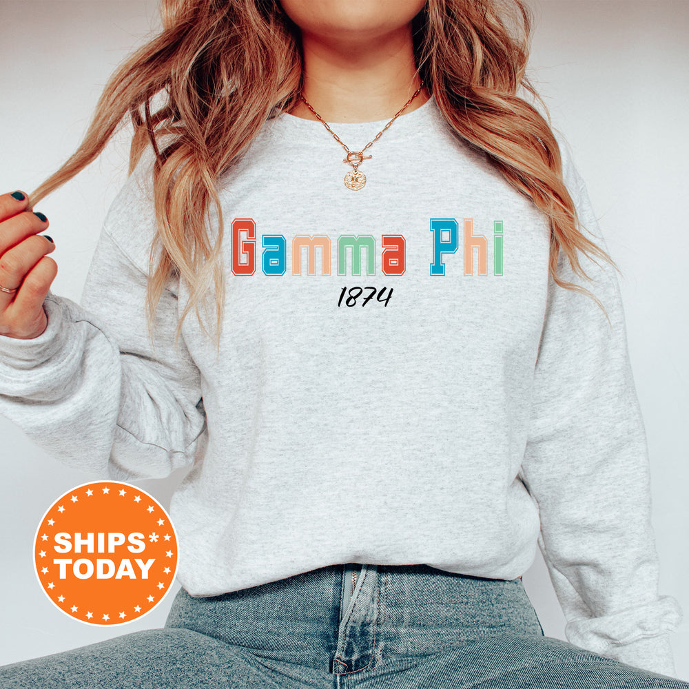a woman wearing a sweatshirt with the words gama phi printed on it