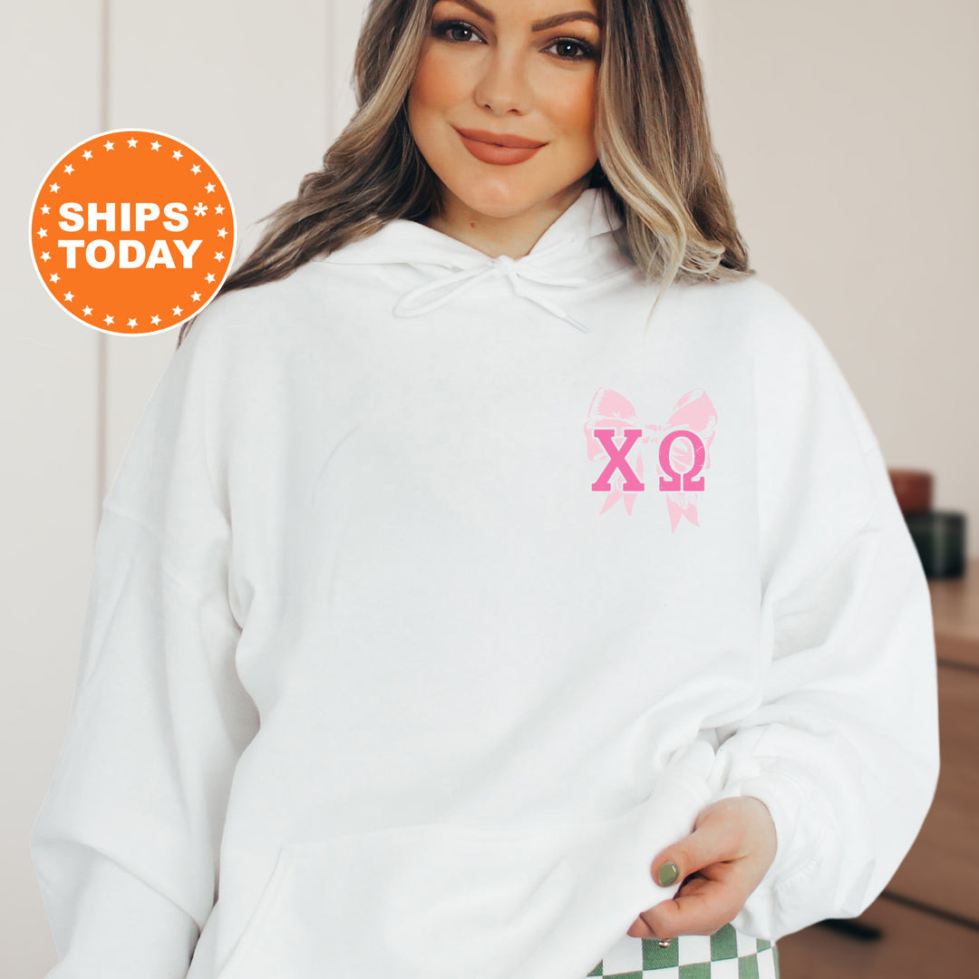 a woman wearing a white hoodie with a pink xo on it