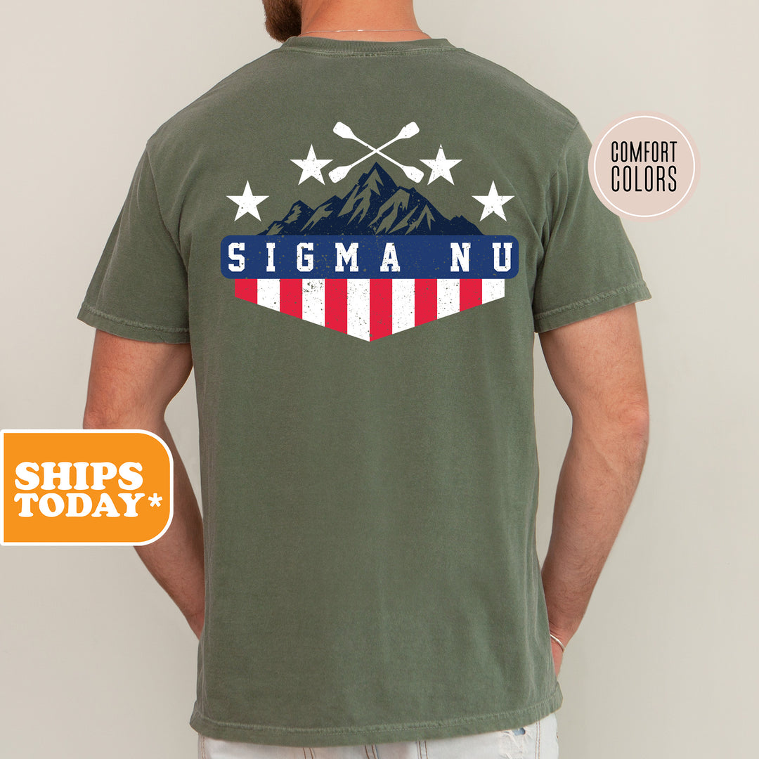 a man wearing a t - shirt with the american flag and mountains on it