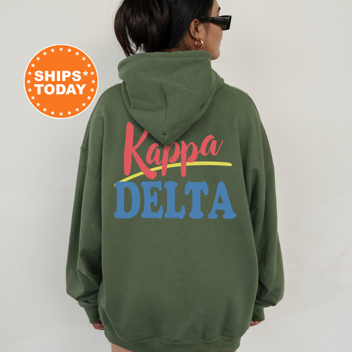 A person wearing a green hoodie with the text " Kappa Delta" printed on it.