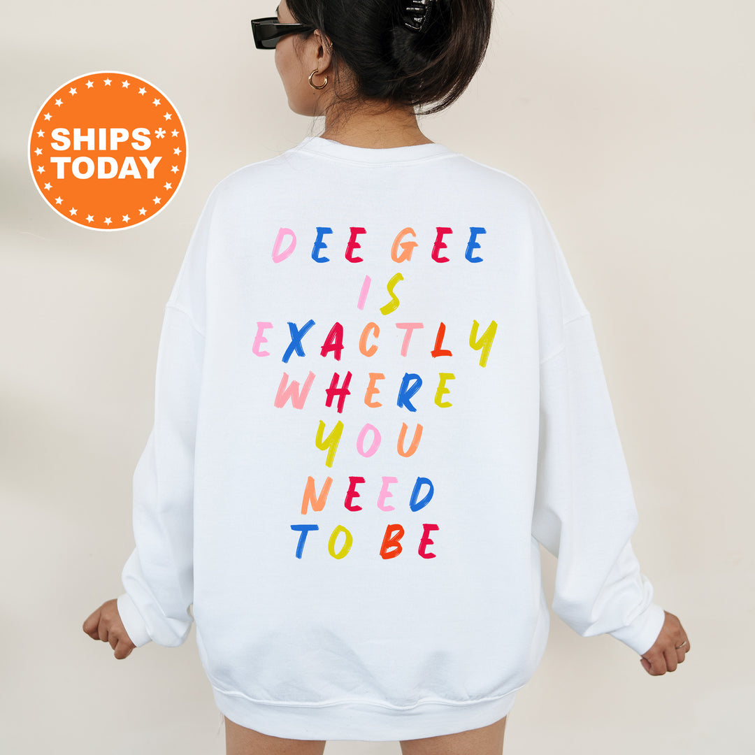 a woman wearing a white sweatshirt with colorful letters on it