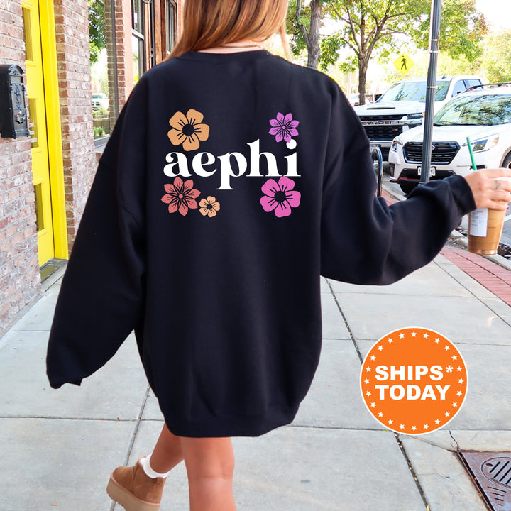 a woman walking down a sidewalk wearing a sweatshirt