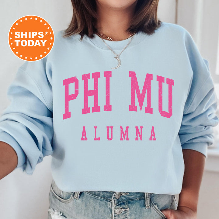 a woman wearing a blue sweatshirt with pink letters on it