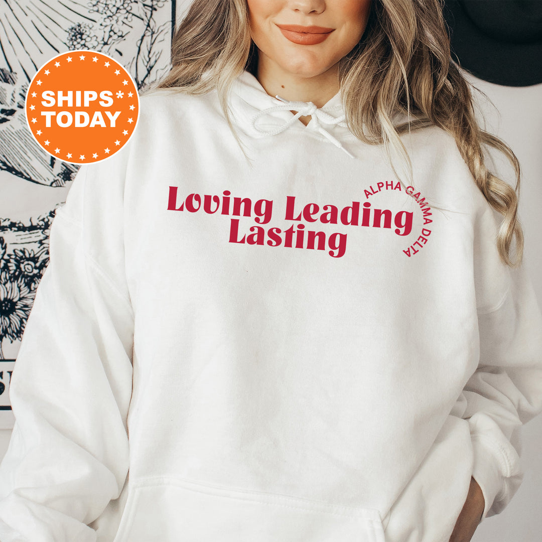 a woman wearing a white hoodie that says loving leading
