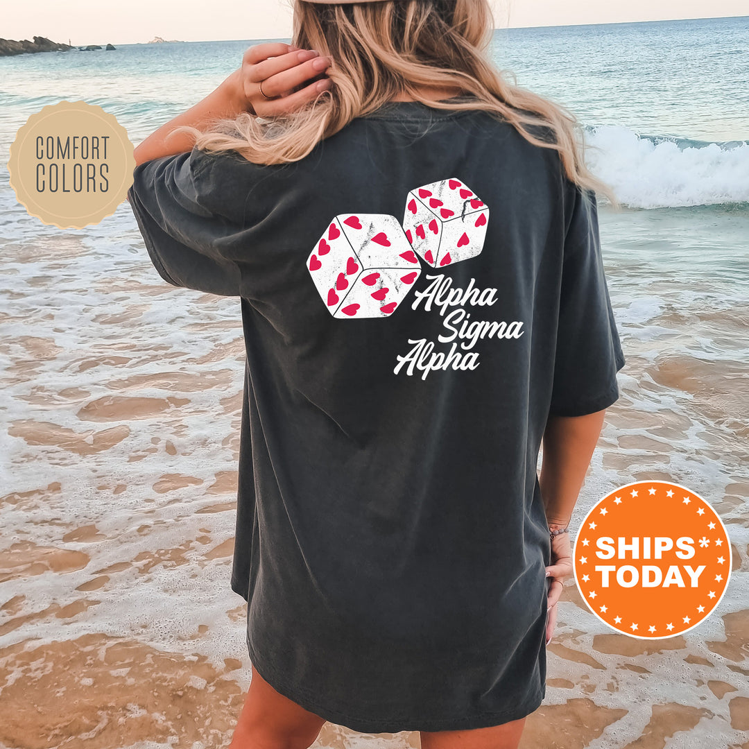 a woman standing on a beach wearing a black shirt