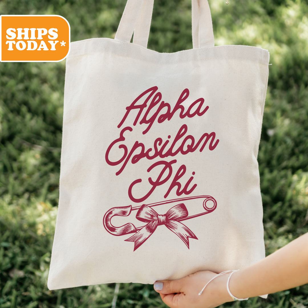 a person holding a tote bag with a ribbon on it