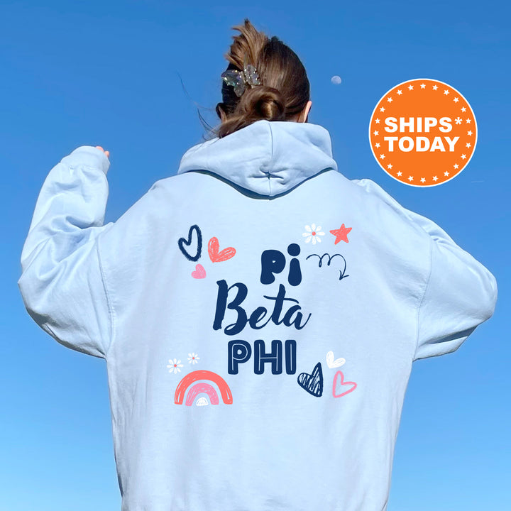 a woman wearing a white hoodie with a rainbow on it