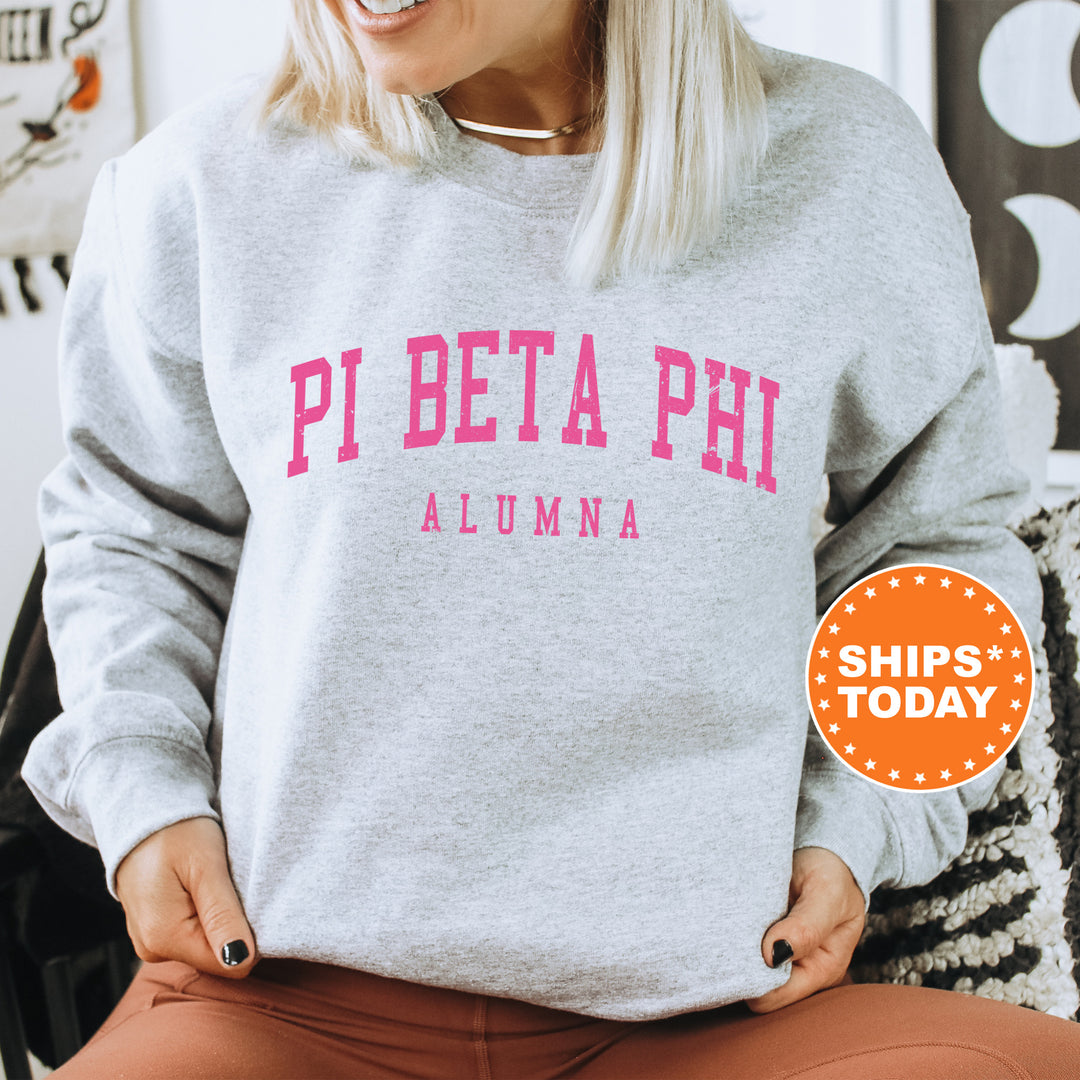 a woman wearing a sweatshirt that says pi beta phi aluma