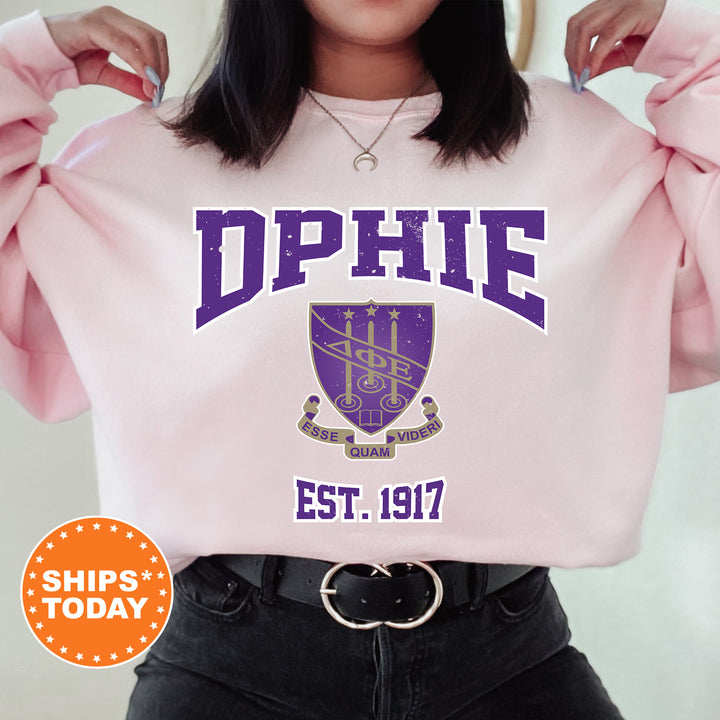 a woman wearing a pink sweatshirt with purple letters on it