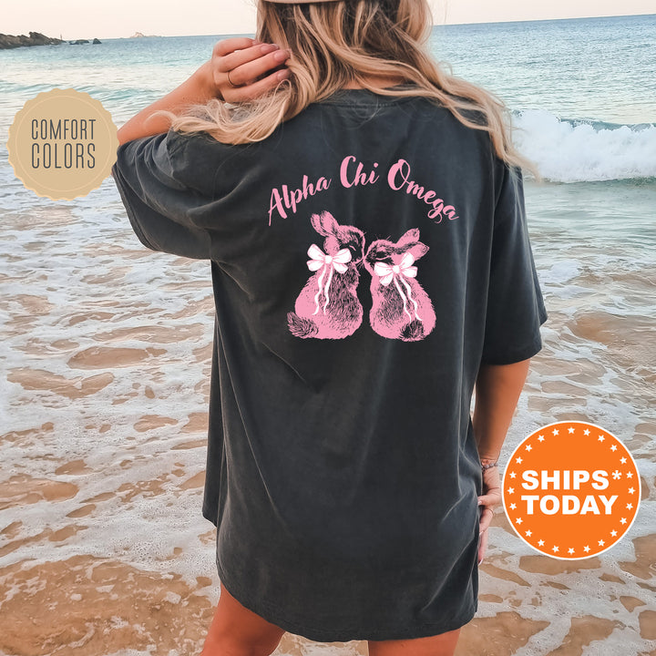 a woman standing on a beach wearing a black shirt