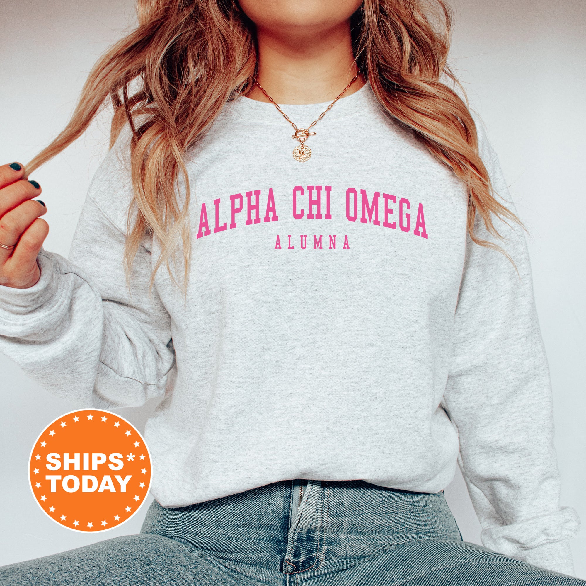 a woman wearing a sweatshirt with the words aloha chi omega on it