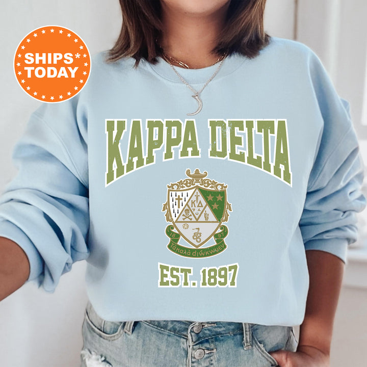 a woman wearing a blue sweatshirt with the words kappea delta on it