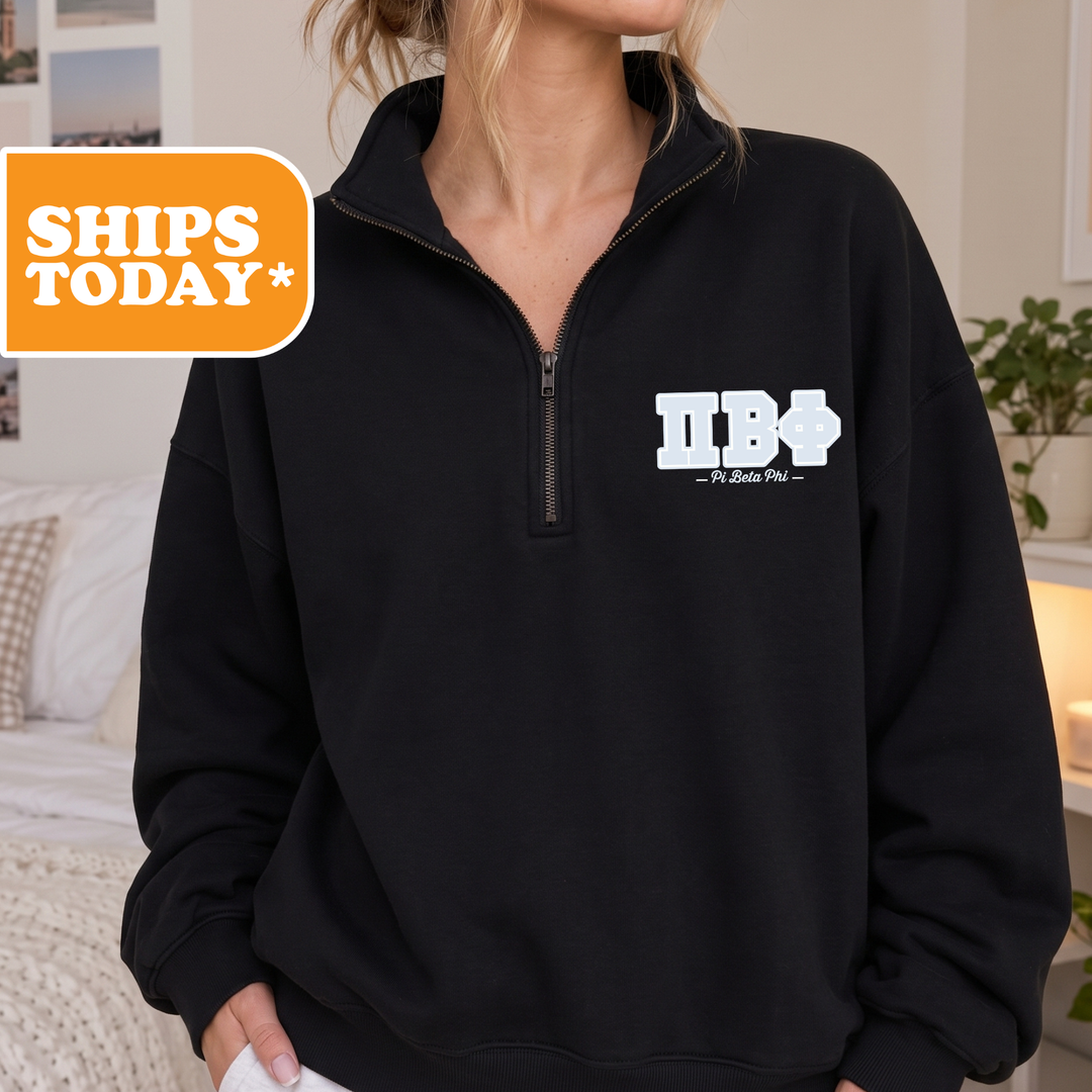 A person wearing a black sweatshirt with a logo on the front.