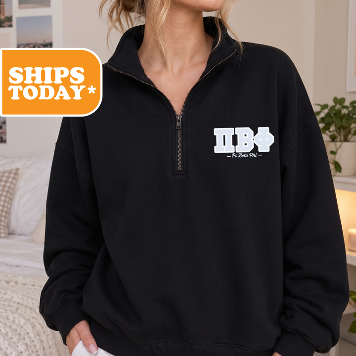 A person wearing a black sweatshirt with a logo on the front.