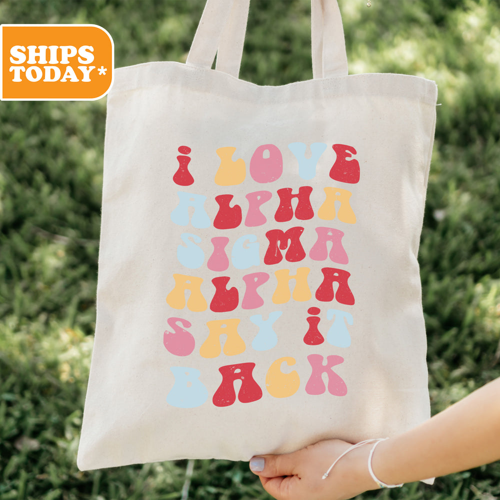 a person holding a tote bag that says love is in the air