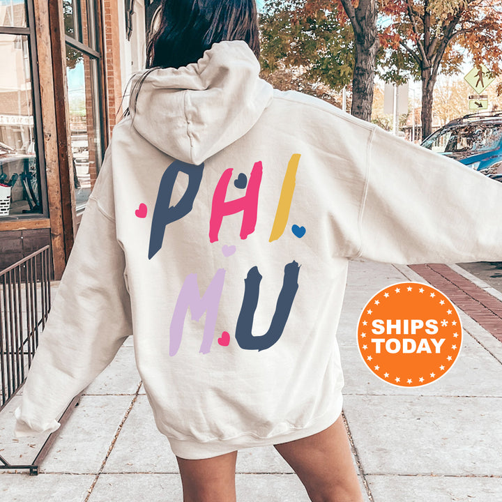 a woman walking down a sidewalk wearing a white hoodie