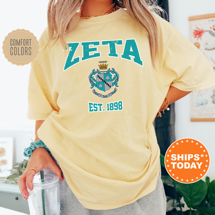 a woman wearing a yellow zeta t - shirt