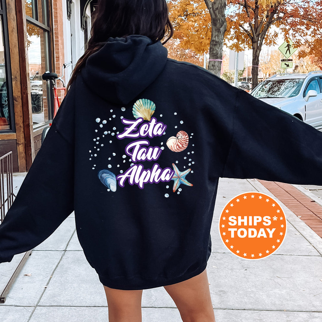 a woman in a black hoodie is walking down the street