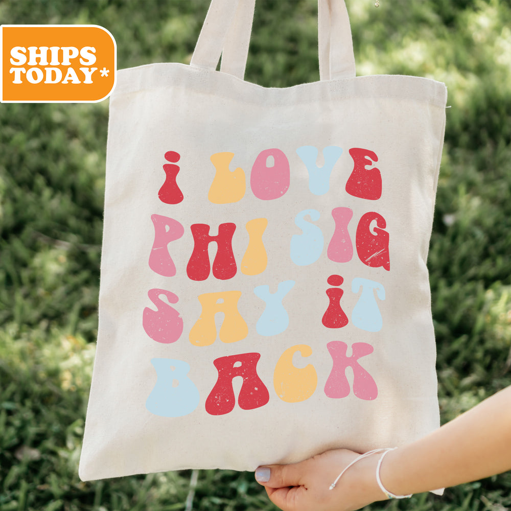a person holding a tote bag with the words love, hugs, and ski