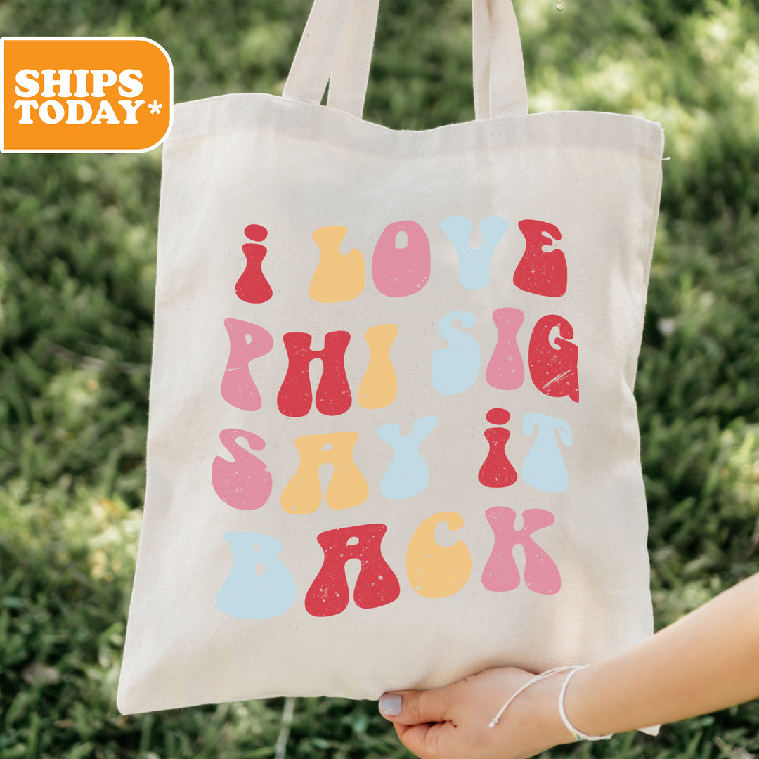 a person holding a tote bag with the words love, hugs, and ski