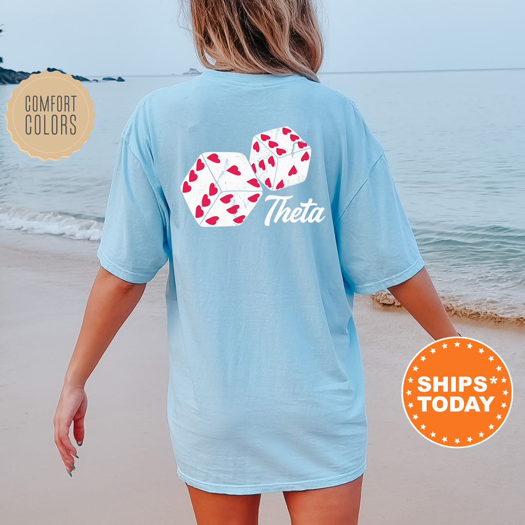 a woman walking on the beach wearing a blue shirt