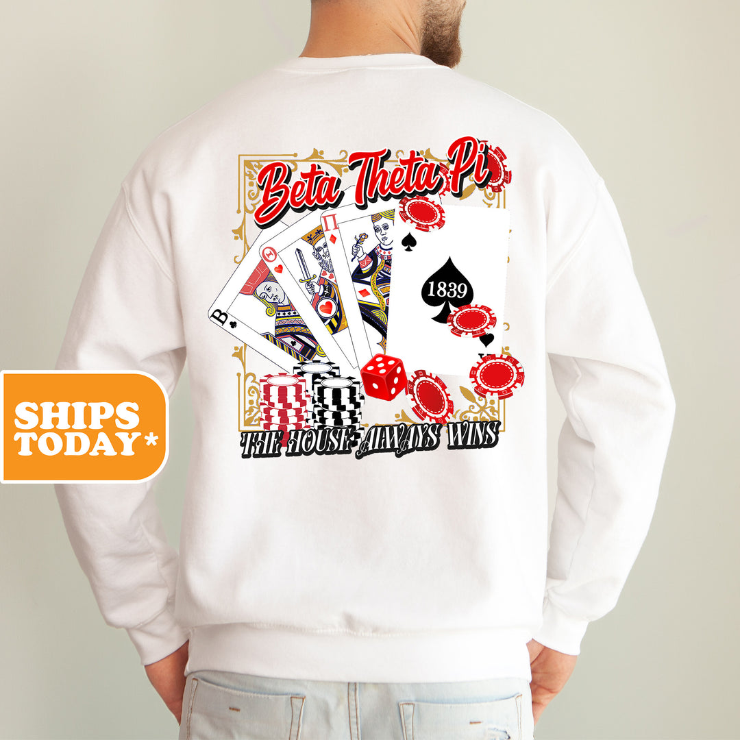 a man wearing a white sweatshirt with a picture of a deck of cards on it