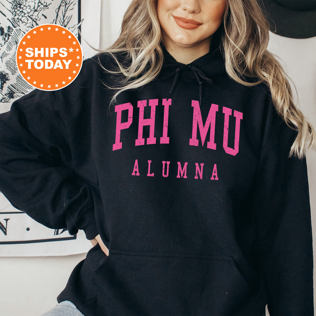 a woman wearing a black phi mu hoodie