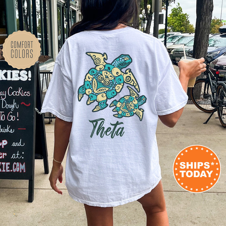 A person wearing a white t-shirt with a colorful turtle design is walking on a sidewalk.