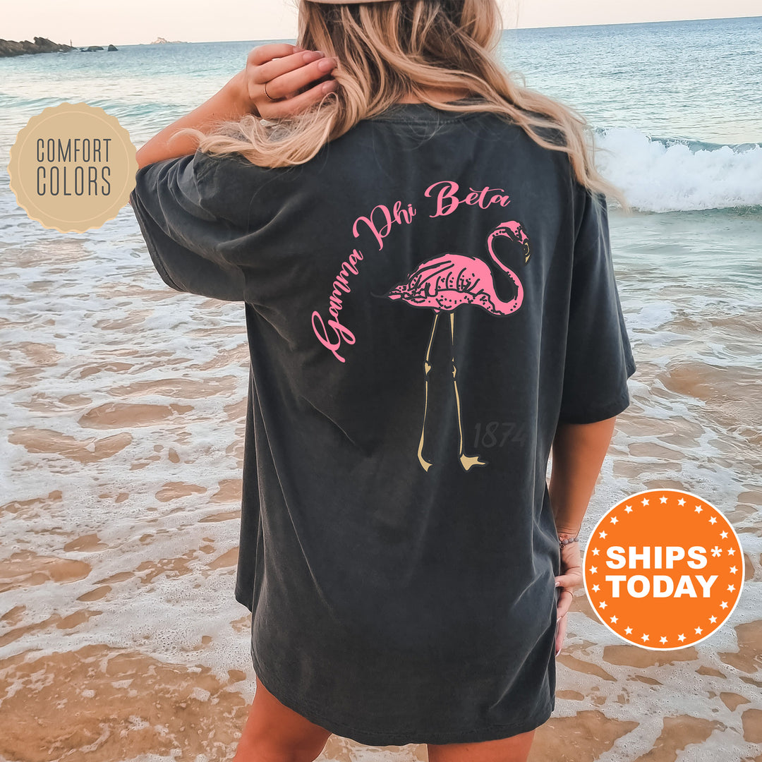 a woman standing on a beach wearing a pink flamingo shirt