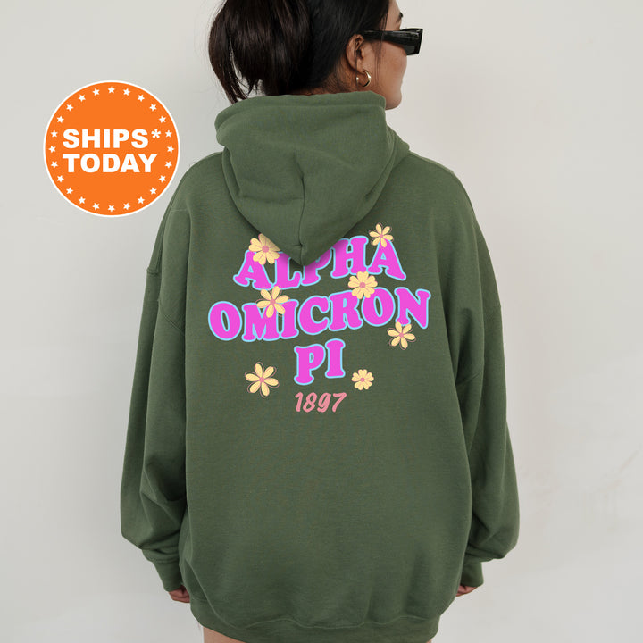 A person wearing a green hoodie with the text "ALPHA OMON Pi 1997" printed on it.