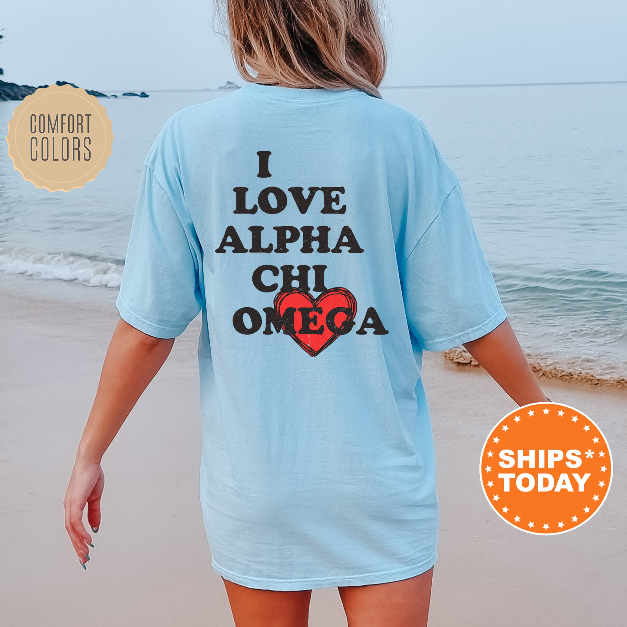 a woman walking on the beach wearing a blue shirt