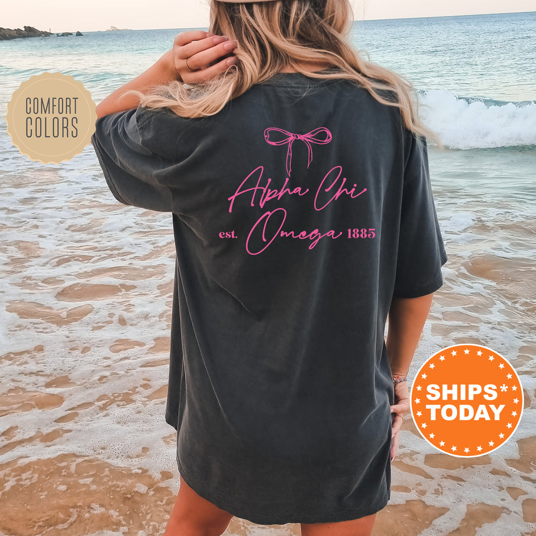 a woman standing on a beach wearing a black shirt