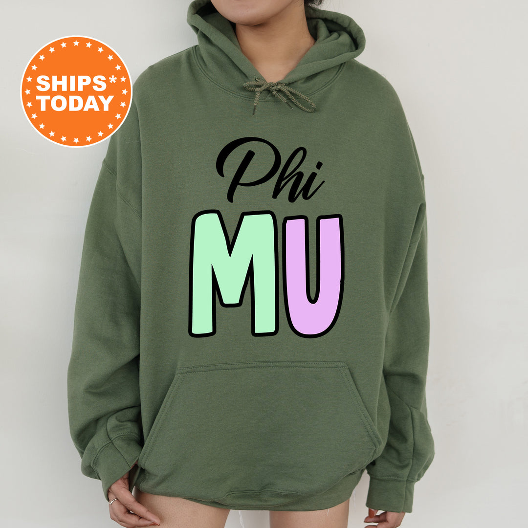 a woman wearing a green phi mu hoodie