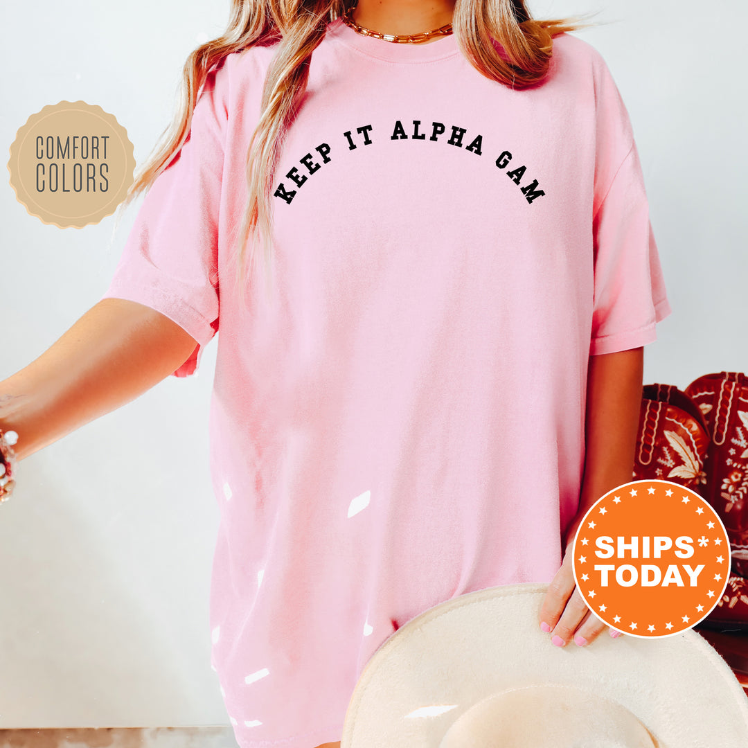 a woman wearing a pink shirt that says keep it alpa bay