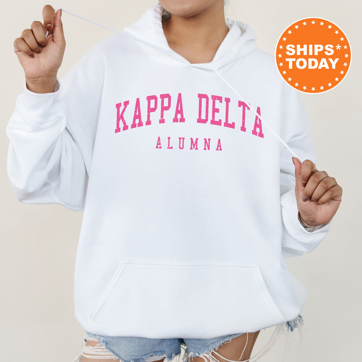a woman wearing a white hoodie with pink letters on it