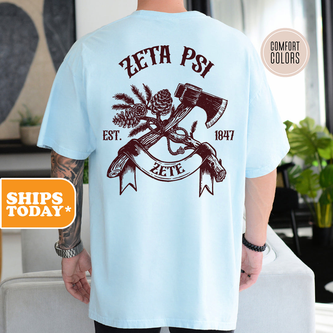 a man wearing a blue zetta psi t - shirt with a hammer and